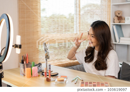 Beautiful woman with a social media influence is greeting the audience for recording vlog video live streaming, Showing how to make up and use cosmetics, Online business on concept of beauty bloggers. 103619097