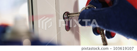 Repairman checking keys and lock of plastic window 103619107