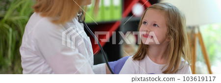 Doctor pediatrician examining little smiling girl with stethoscope 103619117
