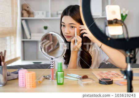 Beautiful women with social media influences are teaching makeup and use cosmetics, In front of the camera to recording vlog video live streaming, Online business on concept of beauty bloggers. 103619243