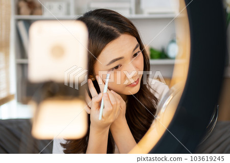 Beautiful women with social media influences are teaching makeup and use cosmetics, In front of the camera to recording vlog video live streaming, Online business on concept of beauty bloggers. 103619245