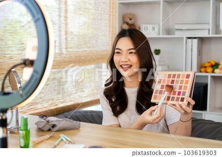 Beautiful women with social media influences are teaching makeup and use cosmetics, In front of the camera to recording vlog video live streaming, Online business on concept of beauty bloggers. Beautiful women with social media influences are teaching makeup and use cosmetics, In front of the camera to recording vlog video live streaming, Online business on concept of beauty bloggers. 103619303