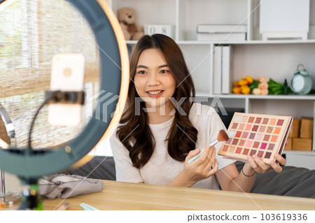 Beautiful women with social media influences are teaching makeup and use cosmetics, In front of the camera to recording vlog video live streaming, Online business on concept of beauty bloggers. Beautiful women with social media influences are teaching makeup and use cosmetics, In front of the camera to recording vlog video live streaming, Online business on concept of beauty bloggers. 103619336