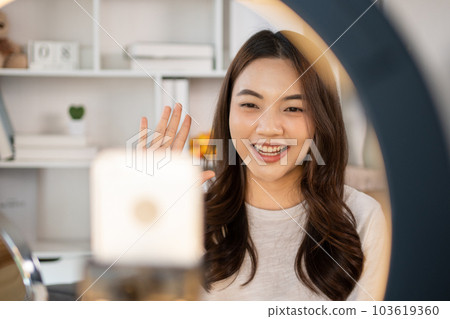 Beautiful woman with a social media influence is greeting the audience for recording vlog video live streaming, Showing how to make up and use cosmetics, Online business on concept of beauty bloggers. 103619360