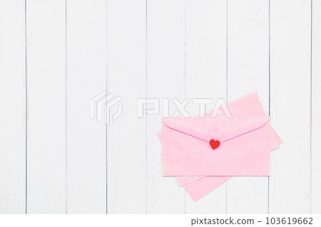 Flat lay of pink envelope with red heart on white table background Flat lay of pink envelope with red heart on white table background 103619662