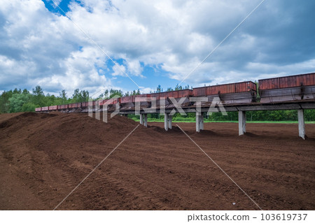 peat transport wagons at the loading point. Raised platform for loading and unloading peat. 103619737