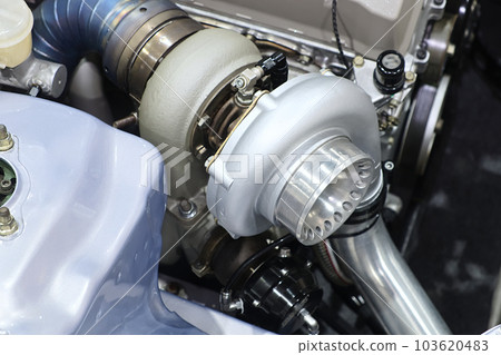 Close-up turbo engine on car bonnet for modify and tune up power speed of car 103620483