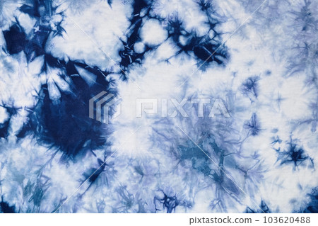 Close-up batik shirt with indigo blue dye on white fabric cotton background on top-view Close-up batik shirt with indigo blue dye on white fabric cotton background on top-view 103620488