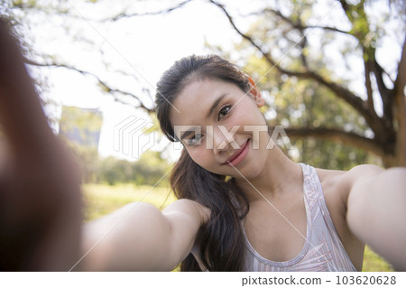 Asian woman taking a selfie in the city. 103620628