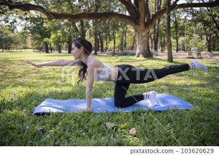 Asian woman doing yoga in the garden. Asian woman doing yoga in the garden. 103620629