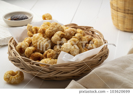 Crispy pork rinds,deep fried pork skin on wicker basket,yummy snacks food. 103620699