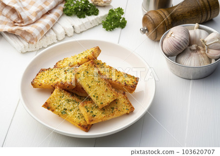 Crispy Garlic Bread on white plate.Air fryer bread with butter garlic and parsley.Snack food 103620707