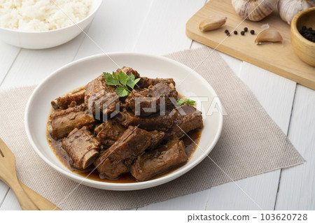 Braised pork spare ribs with soy sauce in white plate 103620728