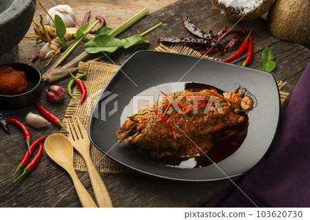 Fish with Red Curry Sauce,Thai food,Climbing gourami fish in Dried spicy curry paste mix with coconut milk in white plate(Chu Chee Pla) 103620730
