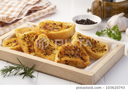 Crispy Garlic bacon Bread on wooden plate.Air fryer bread with butter garlic and parsley.Snack food Crispy Garlic bacon Bread on wooden plate.Air fryer bread with butter garlic and parsley.Snack food 103620743