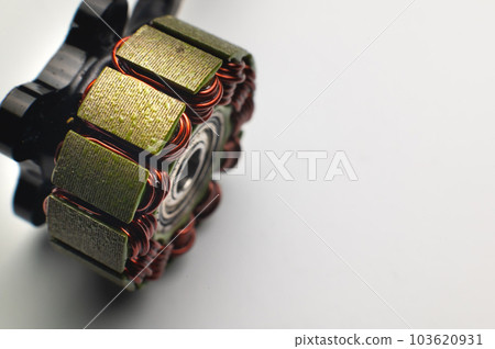 Disassembled brushless motor without bell. Motor winding on a white background Disassembled brushless motor without bell. Motor winding on a white background 103620931