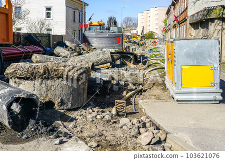 Underground communications replacement site with dewatering system and excavator on a city street Underground communications replacement site with dewatering system and excavator on a city street 103621076