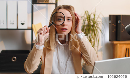 Business woman holding magnifying glass near face, looking with big zoomed eye, searching, analysing Business woman holding magnifying glass near face, looking with big zoomed eye, searching, analysing 103624056