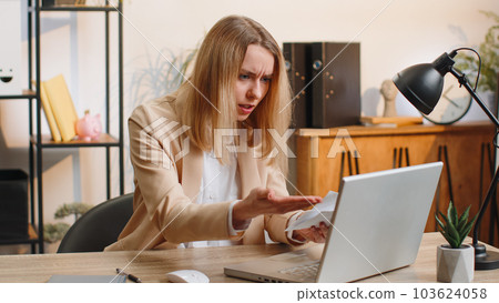 Stressed businesswoman work at unpaid bank debt, doing paperwork planning budget, throws paper bills 103624058