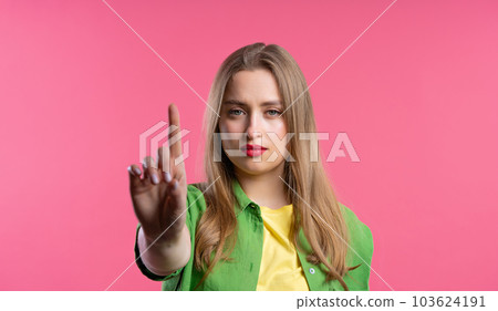 Uninterested woman disapproving with NO finger sign gesture. Attention. Uninterested woman disapproving with NO finger sign gesture. Attention. 103624191