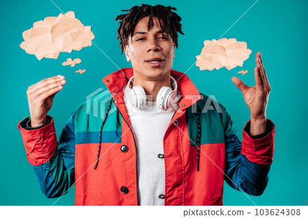 Irritated young african man showing bla-bla gesture with hands on blue studio Irritated young african man showing bla-bla gesture with hands on blue studio 103624308