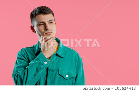 Thinking puzzled man on pink background. Guy looking for answer, copy space 103624418