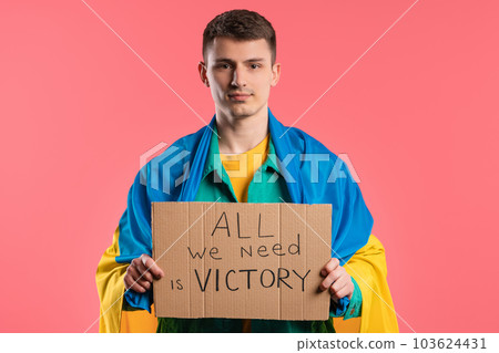 Ukrainian man with cardboard All we need is victory on pink background. Ukrainian man with cardboard All we need is victory on pink background. 103624431