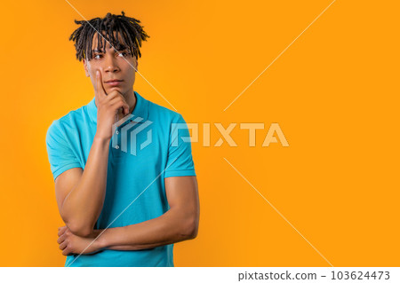 Thinking puzzled man on yellow background. Guy looking for answer, copy space 103624473