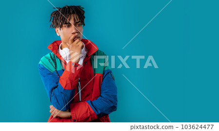 Thinking puzzled man on blue background. Guy looking for answer, copy space 103624477