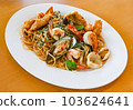noodles plate with spaghetti pasta stir fried with vegetables herb spicy tasty appetizing asian noodles mix seafood stir fried shrimp squid shellfish fish with basil and chilli pepper 103624641