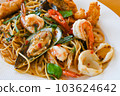 noodles plate with spaghetti pasta stir fried with vegetables herb spicy tasty appetizing asian noodles mix seafood stir fried shrimp squid shellfish fish with basil and chilli pepper 103624642