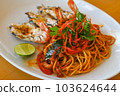 noodles plate with spaghetti pasta stir fried with vegetables herb spicy tasty appetizing asian noodles mix seafood stir fried shrimp squid shellfish fish with basil and chilli pepper 103624644