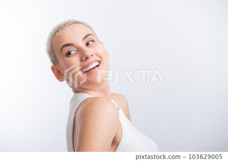Beautiful young caucasian woman with a short haircut on a white background. Beautiful young caucasian woman with a short haircut on a white background. 103629005