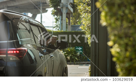 Hand Man in car receiving coffee in drive thru fast food restaurant.  103629059