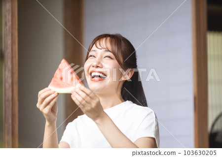 A woman eating watermelon A woman eating watermelon 103630205