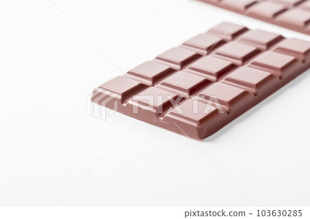 Milk chocolate bar, white background, copy space. Sweet chocolate dessert, top view. AI generated Milk chocolate bar, white background, copy space. Sweet chocolate dessert, top view. AI generated 103630285