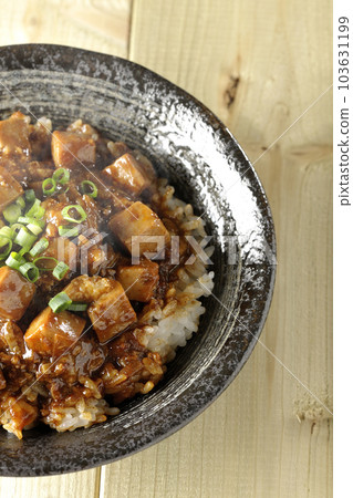 A bird's-eye view of a hot mapo tofu bowl full of small onions and tofu A bird's-eye view of a hot mapo tofu bowl full of small onions and tofu 103631199