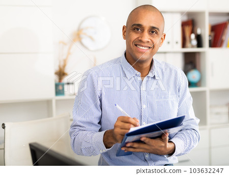 Businessman makes notes in the document at office 103632247