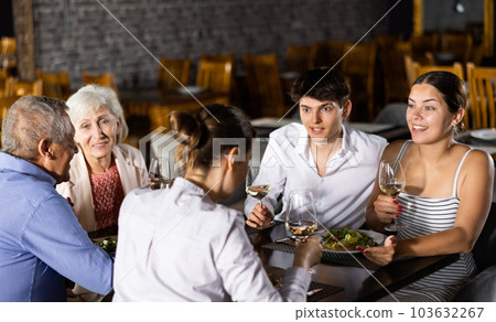 Large family, company of spouses in restaurant, eat, celebrate important event, communicate. Large family, company of spouses in restaurant, eat, celebrate important event, communicate. 103632267