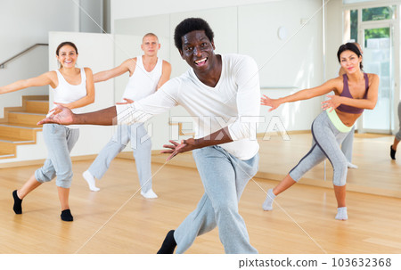 Adult people learning swing steps at dance class Adult people learning swing steps at dance class 103632368