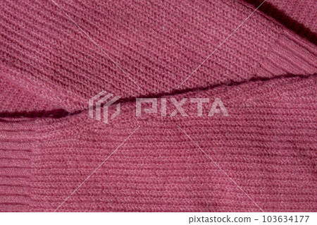 No Lints on pink sweater. Acrylic or wool sweater. After cleaning and collected fluff lint. Closeup sweater. Old used sweater without lint pilling. Restoration of old damaged clothes care. Repairing 103634177