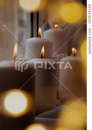 Bokeh light Home fragnance concept autumn holidays at cozy home on the windowsill Hygge aesthetic atmosphere on knitted white sweater. Still life of micro moment candid slow living. Mental health 103634226