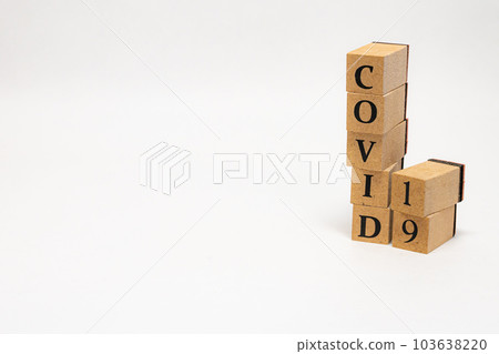 Wooden block English word COVID-19 103638220
