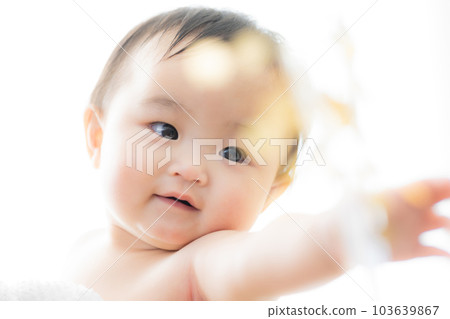 A baby wrapped in a bath towel A baby wrapped in a bath towel 103639867