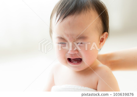 A baby wrapped in a bath towel A baby wrapped in a bath towel 103639876