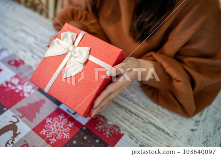 Happy excited asian woman hands holding Christmas gift box. cheerful girl packing Xmas present or open box xmas new year birthday gift. Happy excited asian woman hands holding Christmas gift box. cheerful girl packing Xmas present or open box xmas new year birthday gift. 103640097