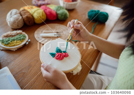 Punch needle. Asian Woman making handmade Hobby knitting in studio workshop. designer workplace Handmade craft project DIY embroidery concept. 103640098