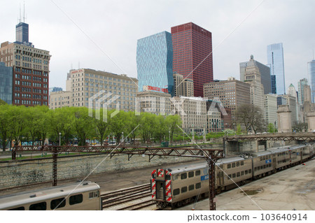 CHICAGO, ILLINOIS, UNITED STATES - MAY 12, 2018: Tracks with switches and trains in downtown Chicago's Grant Park with the skyline in the background CHICAGO, ILLINOIS, UNITED STATES - MAY 12, 2018: Tracks with switches and trains in downtown Chicago's Grant Park with the skyline in the background 103640914