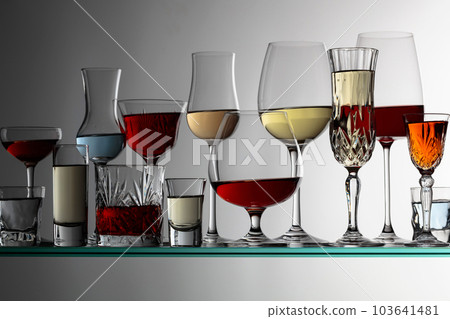 Alcoholic drinks on a glass shelf. Alcoholic drinks on a glass shelf. 103641481