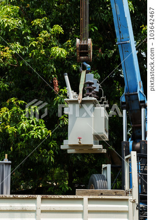 Crane hook lifts up distribution transformer Crane hook lifts up distribution transformer 103642467